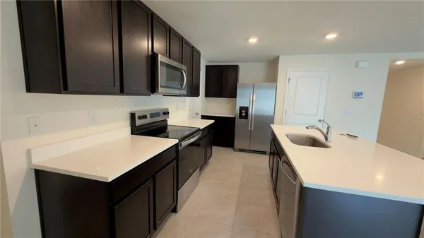 a kitchen with a sink a stove and a refrigerator