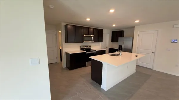 a kitchen with a sink a stove and cabinets