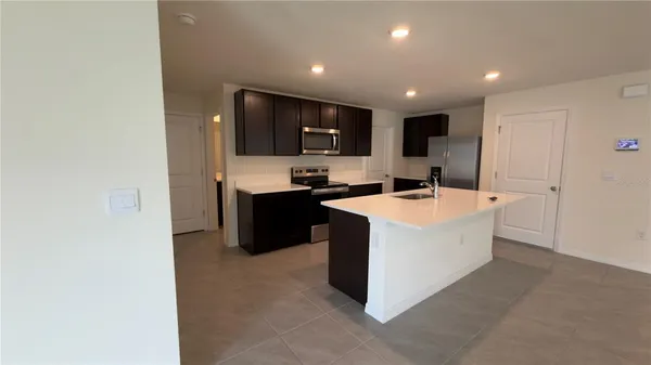 a kitchen with stainless steel appliances a sink stove and cabinets