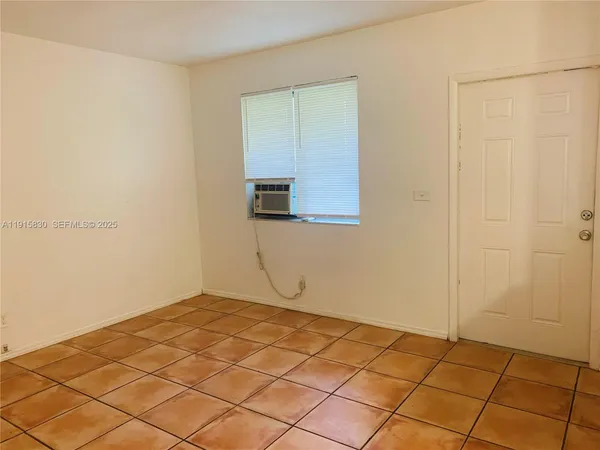 a view of a room with a wooden floor and a shower