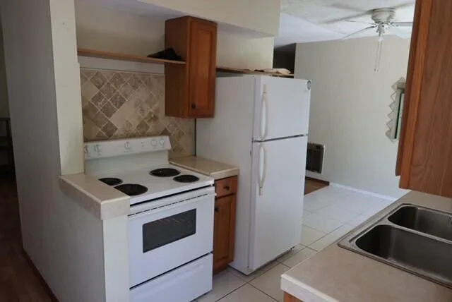 a kitchen with a stove and a refrigerator