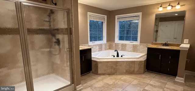 a spacious bathroom with a bathtub and a shower