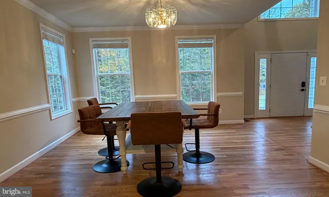 a view of a livingroom with furniture and a window