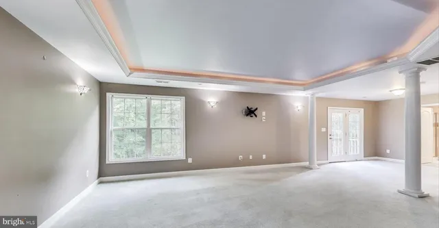 an empty room with windows and closet