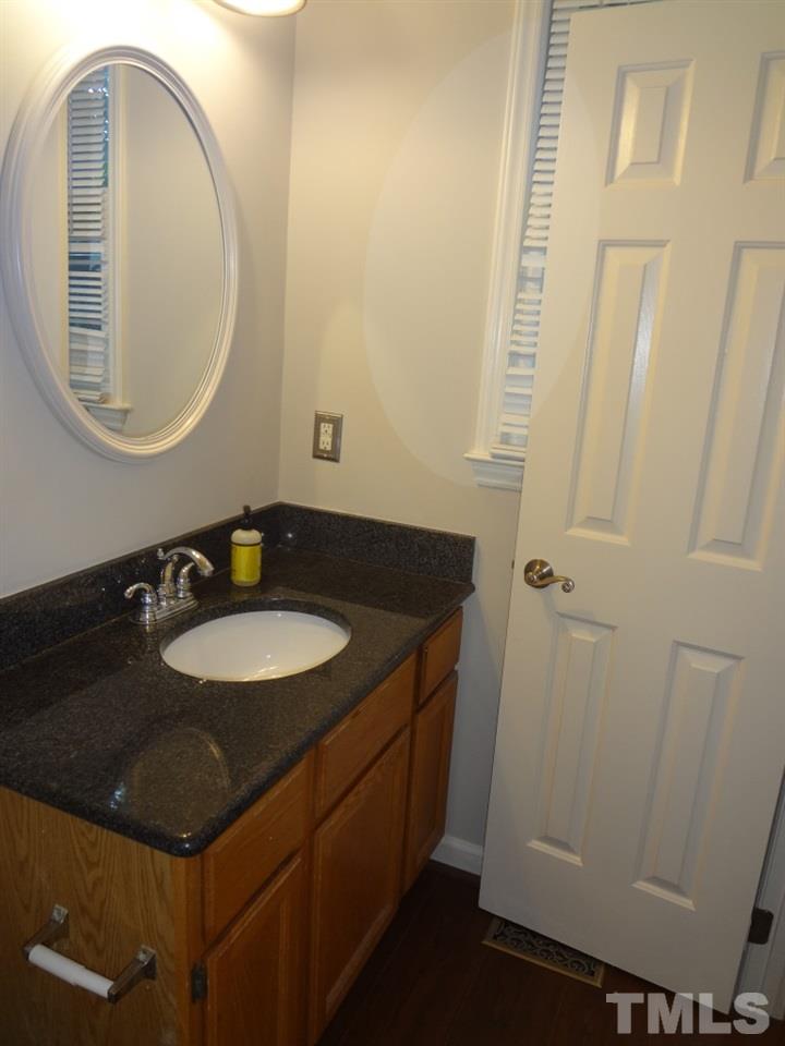 4616 Fisk Court Raleigh, NC 27604 - Photo 22 of 25 a bathroom with a sink and a mirror
