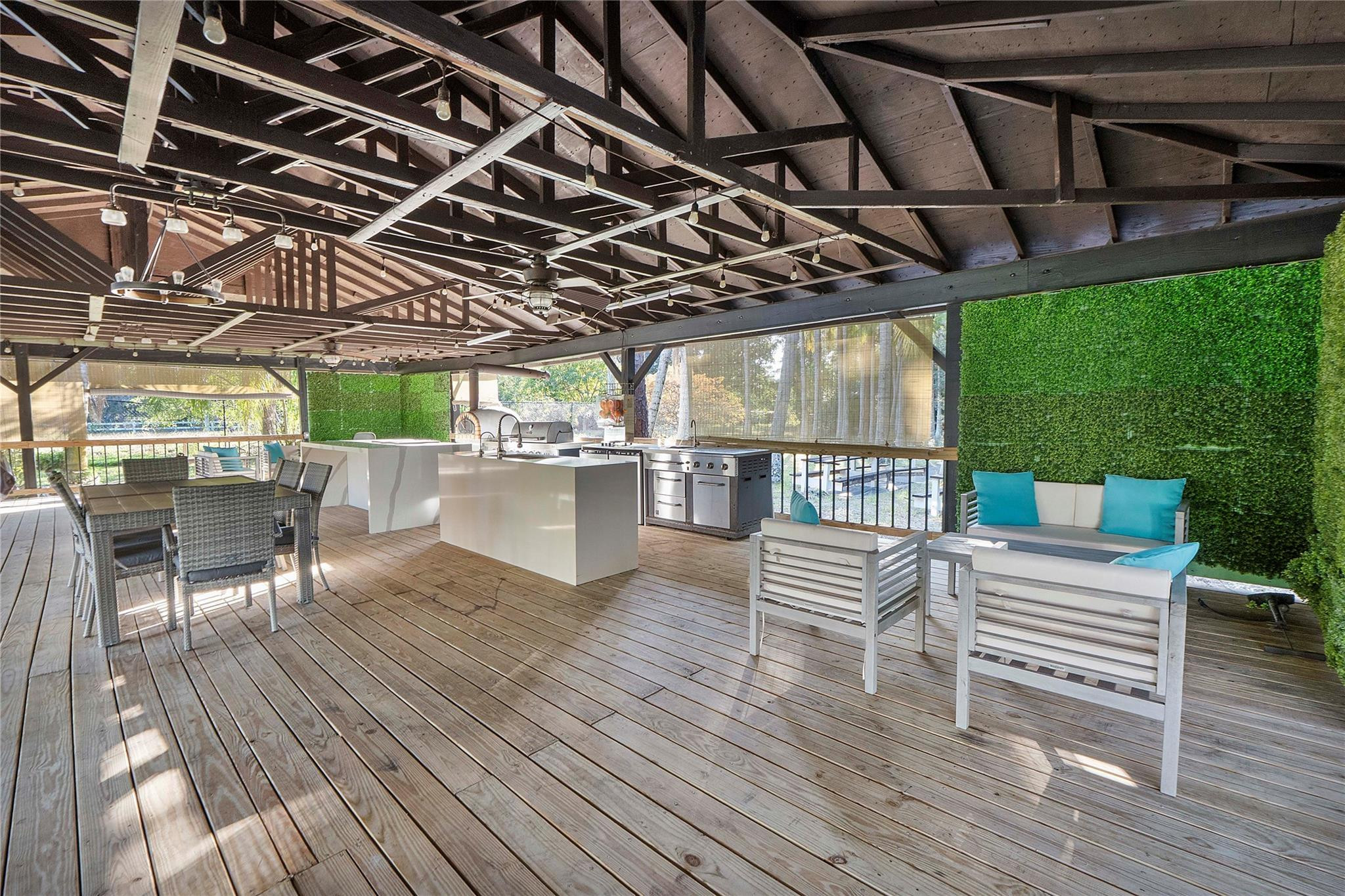 5351 Godfrey Road Parkland, FL 33067 - Photo 87 of 95 a view of a chairs and table in patio with wooden floor