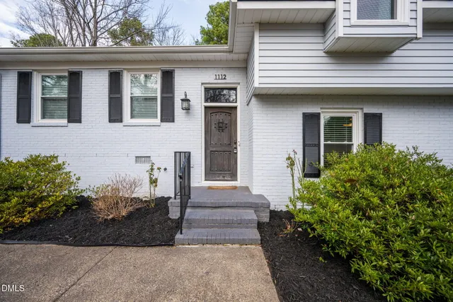 a view of a house with a large window and large tree