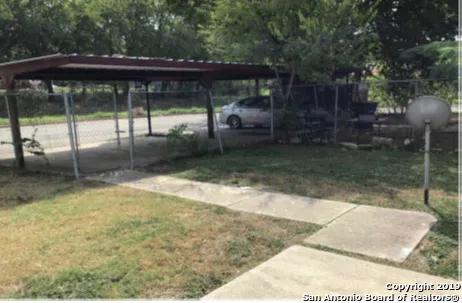 a backyard of a house with yard barbeque oven and outdoor seating