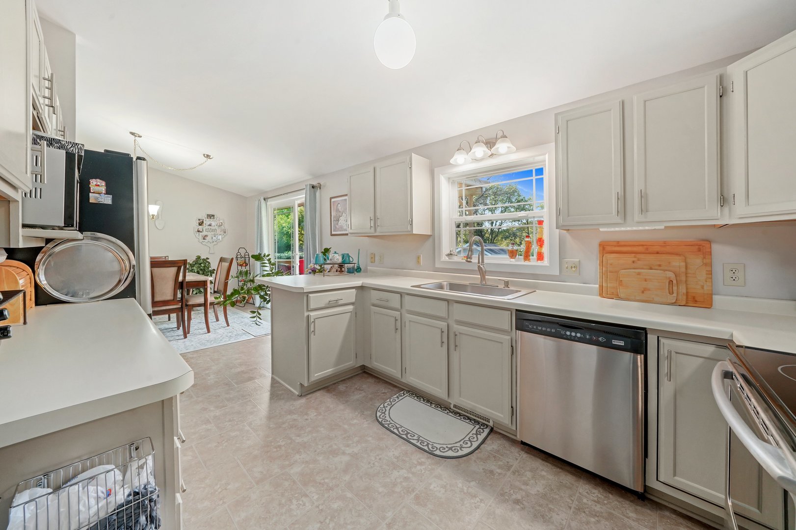 417 Pembroke Road Southwest Poplar Grove, IL 61065 - Photo 2 of 45 a kitchen with a sink cabinets and window