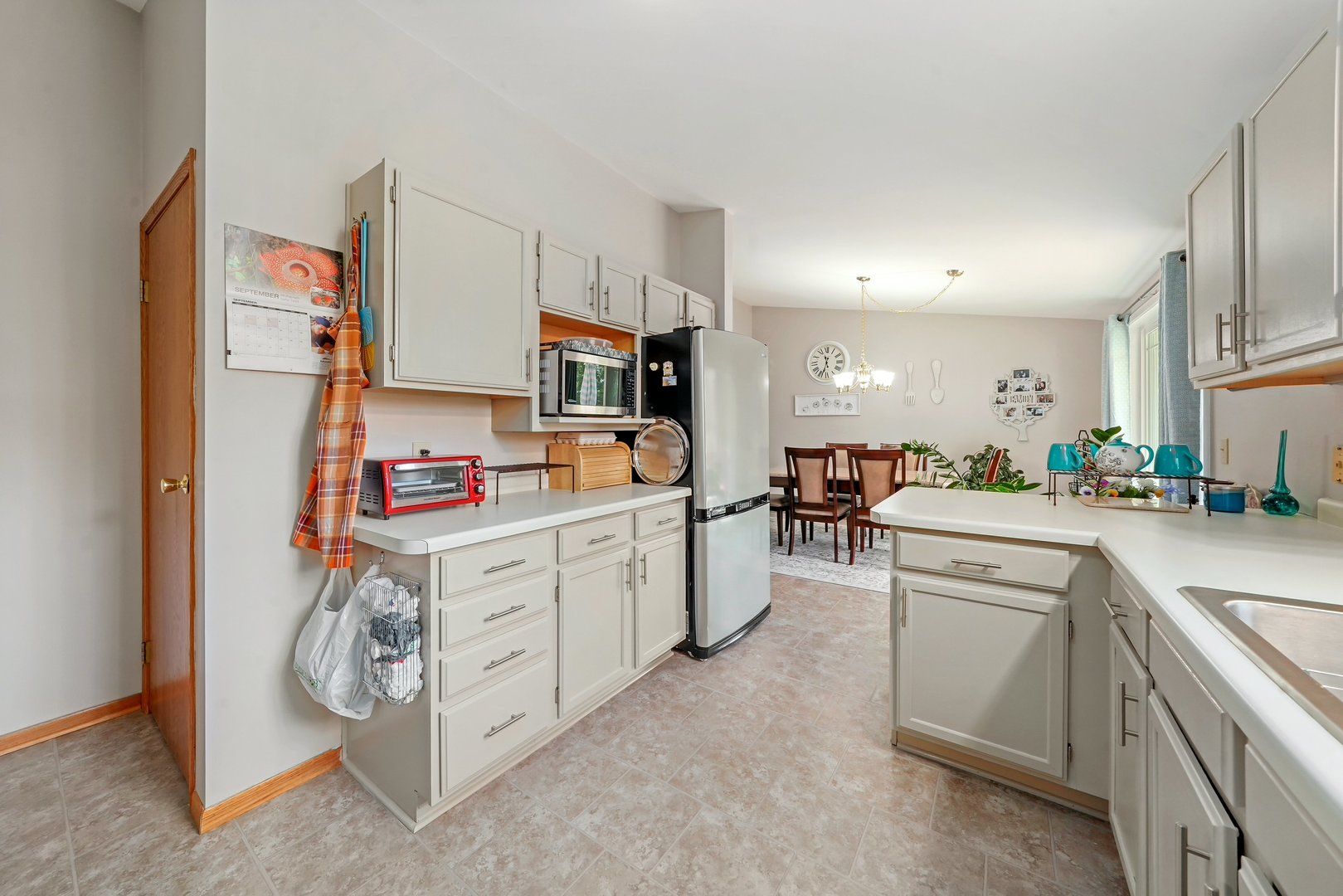 417 Pembroke Road Southwest Poplar Grove, IL 61065 - Photo 4 of 45 a kitchen with cabinets and white appliances