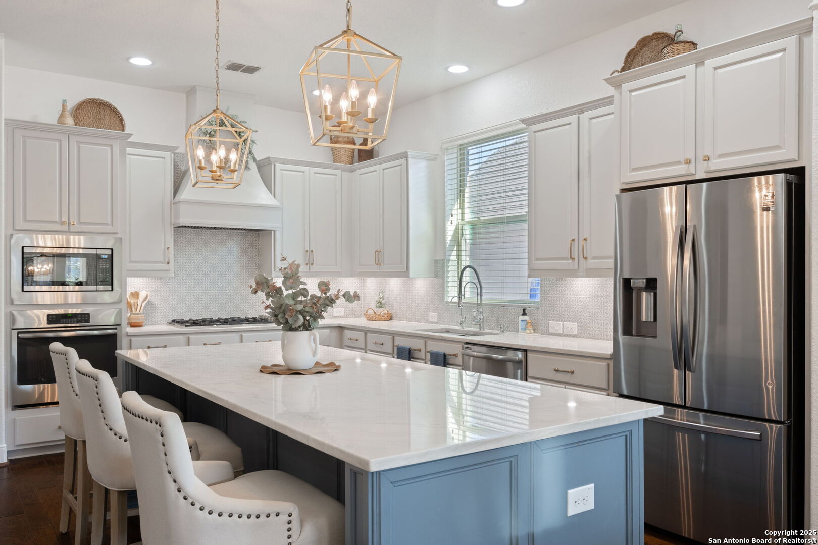 a kitchen with stainless steel appliances a sink stove and refrigerator