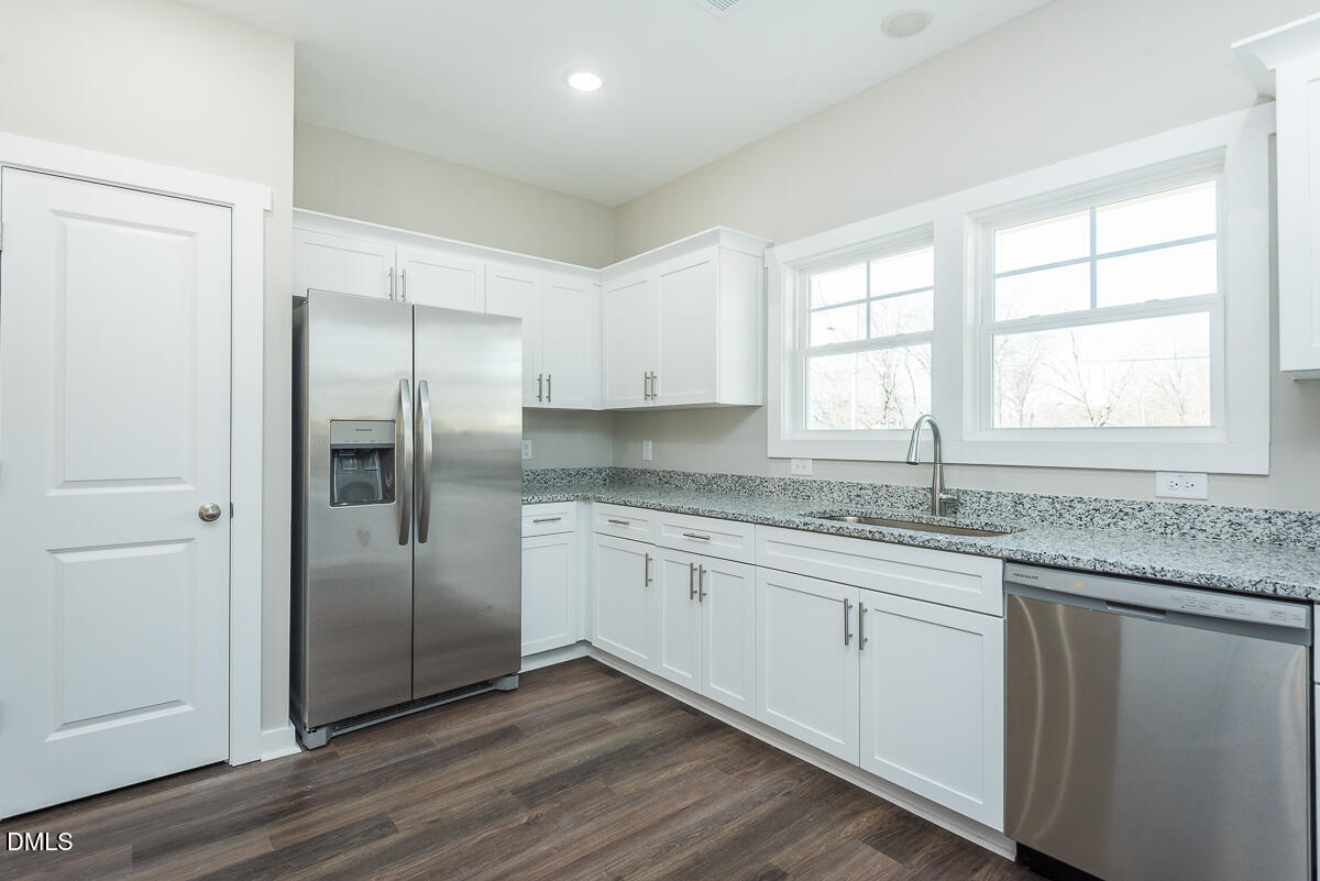 2828 Ricolden Trail Elon, NC 27244 - Photo 5 of 14 a kitchen with granite countertop stainless steel appliances a sink cabinets and a window