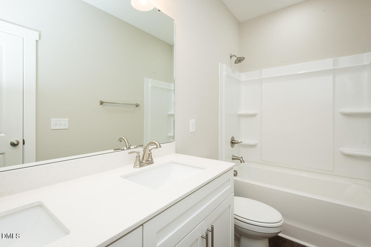 2828 Ricolden Trail Elon, NC 27244 - Photo 9 of 14 a bathroom with a sink a toilet and a bathtub