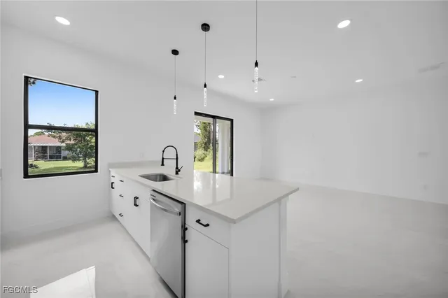 a kitchen with stainless steel appliances a refrigerator and a stove top oven