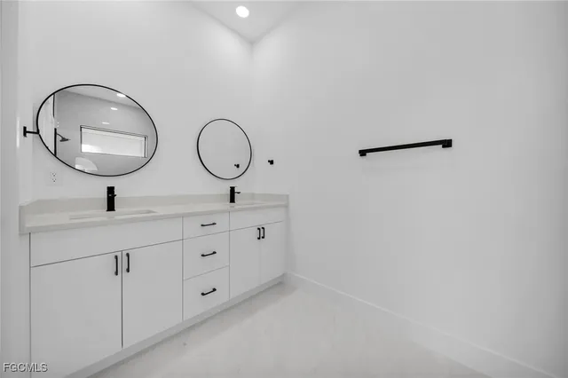a bathroom with 2 sink and a mirror