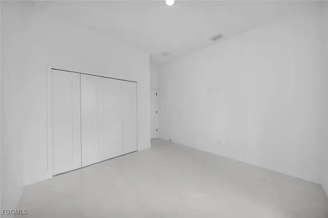 a backyard of a house with plants and outdoor seating