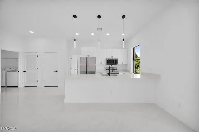 an empty room with windows and closet