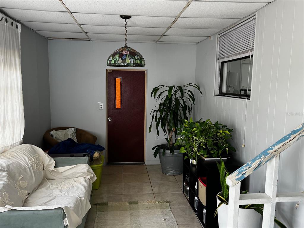 1670 Liberty Bell Street Kissimmee, FL 34758 - Photo 2 of 25 a living room with furniture potted plant and a window