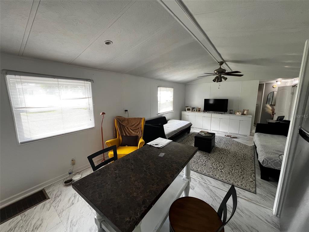 1670 Liberty Bell Street Kissimmee, FL 34758 - Photo 6 of 25 a living room with furniture and a flat screen tv