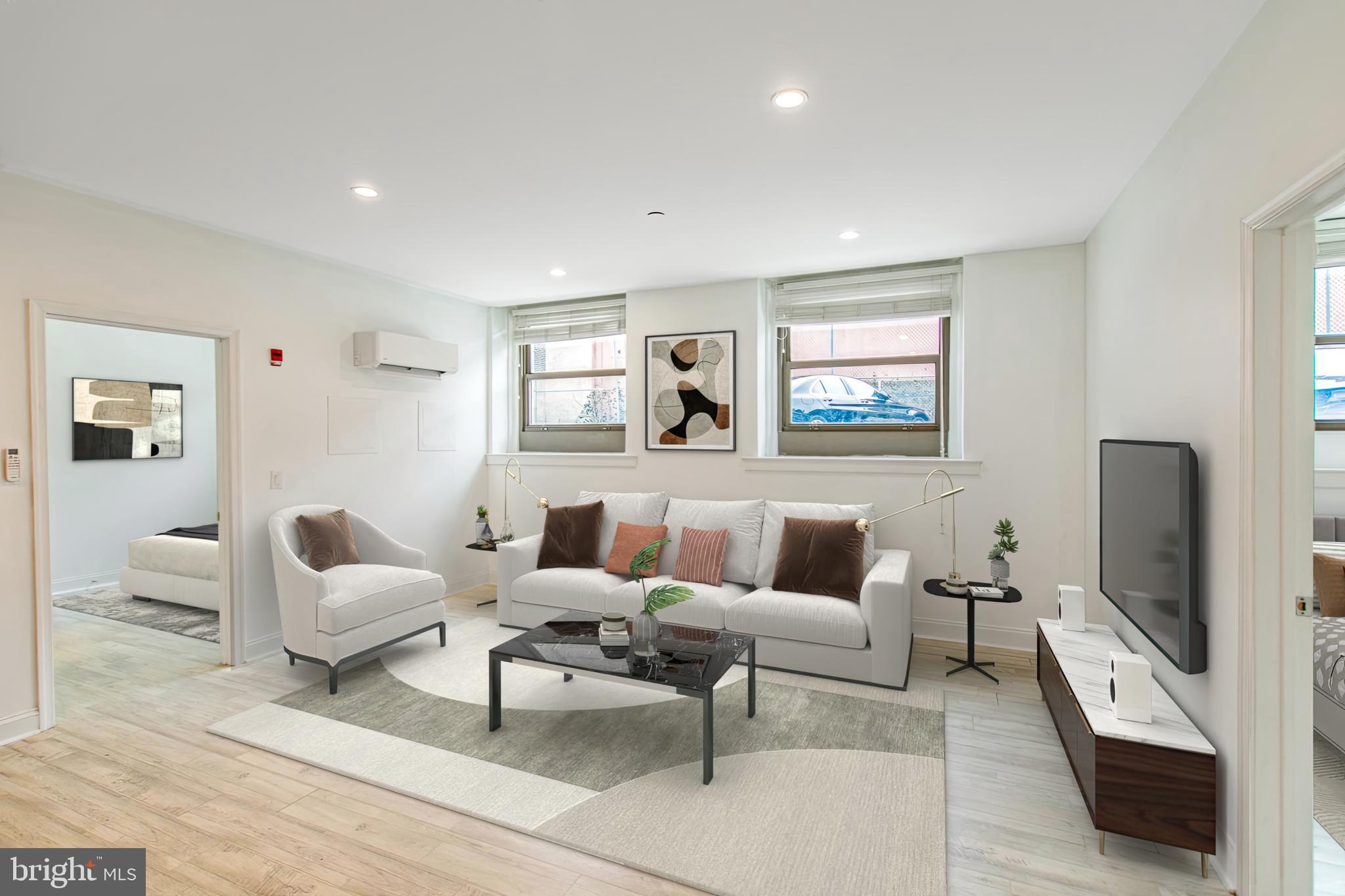 a living room with furniture and a flat screen tv