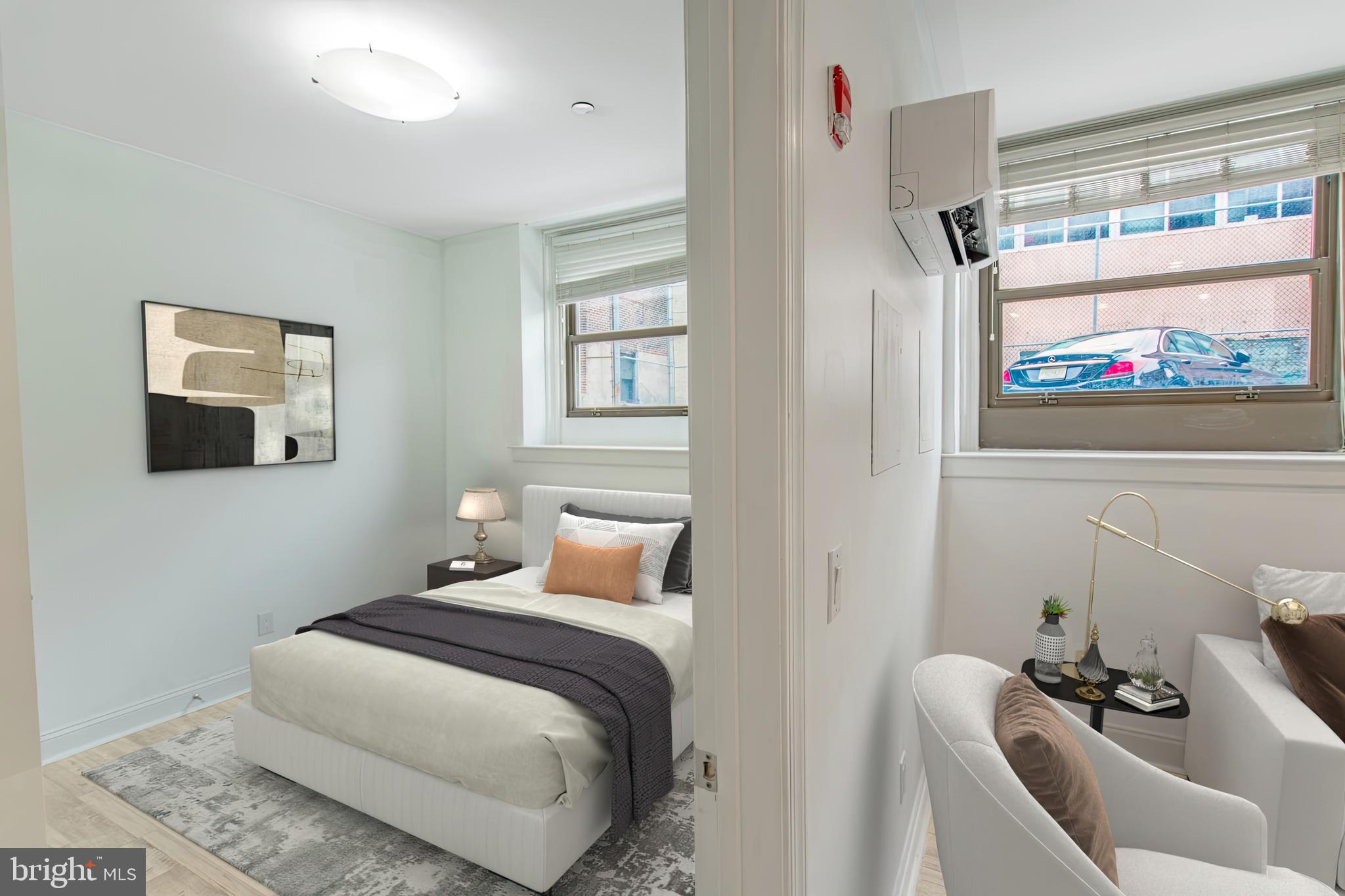 427-33 Monroe Street, Unit 102 Philadelphia, PA 19147 - Photo 3 of 23 a bedroom with a bed and glass window