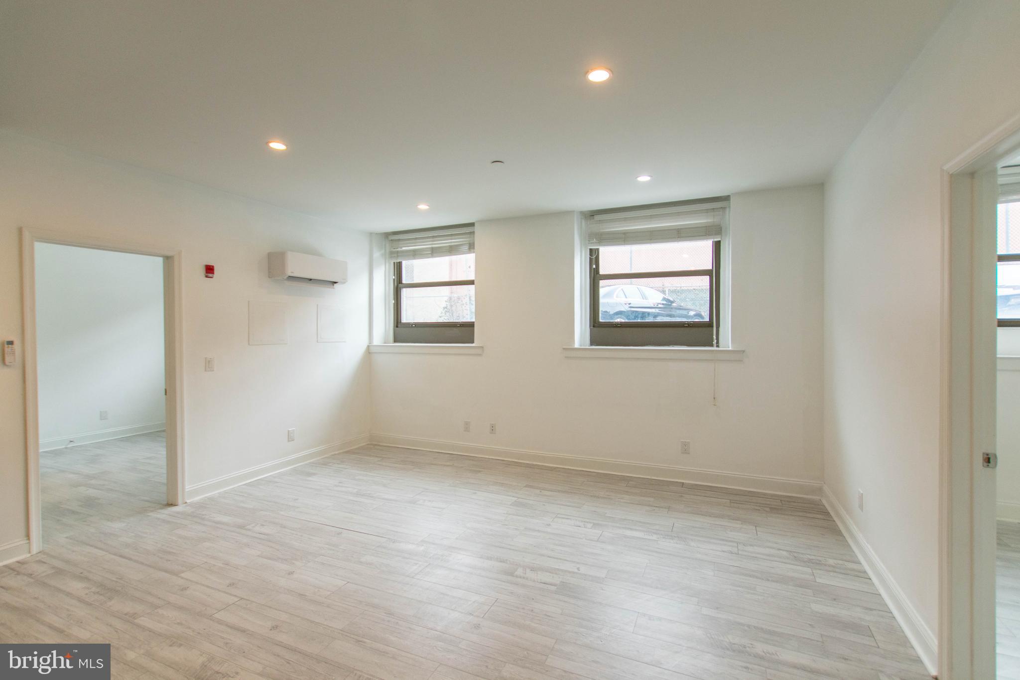 427-33 Monroe Street, Unit 102 Philadelphia, PA 19147 - Photo 7 of 23 an empty room with windows and closet
