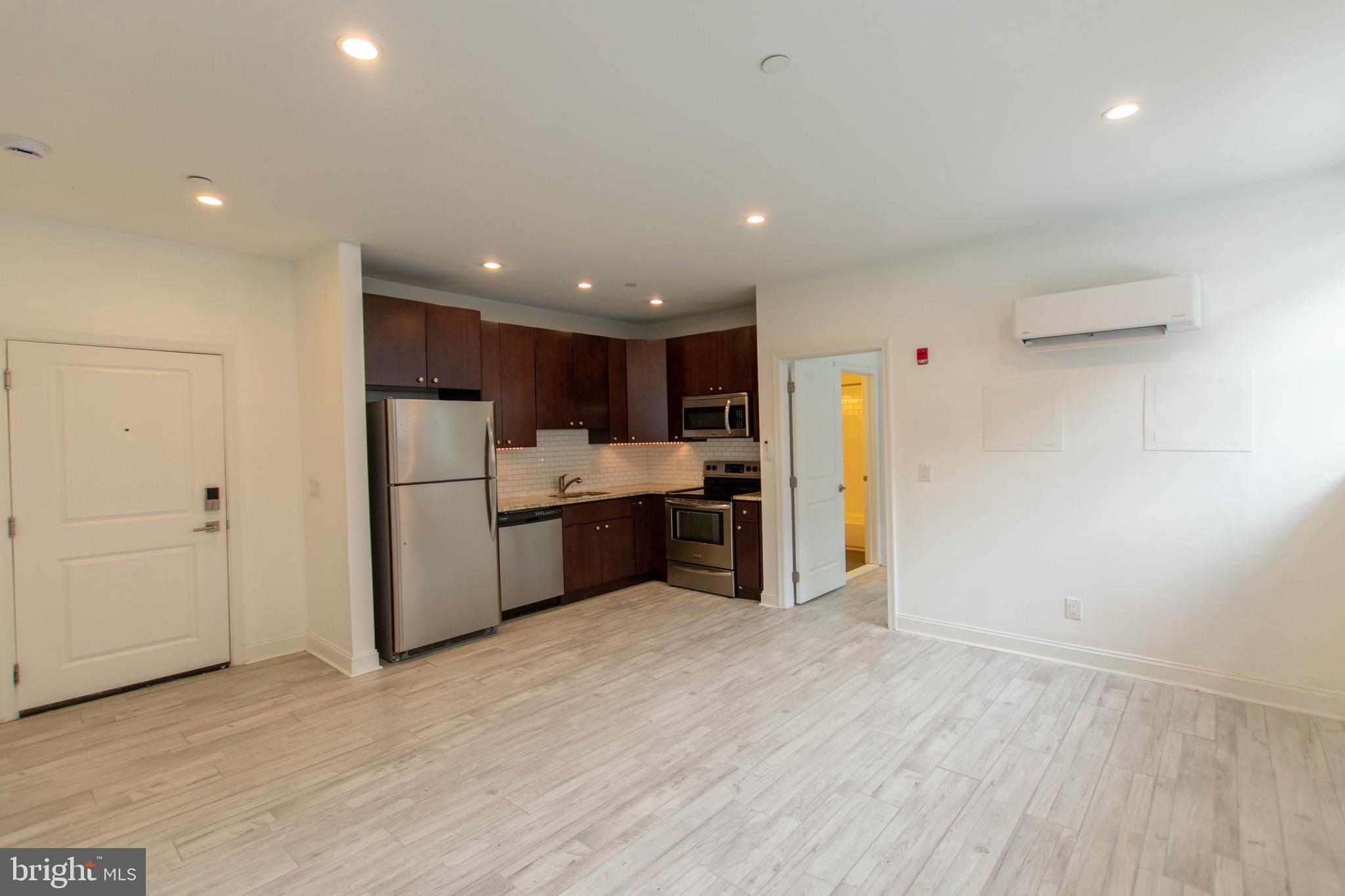 427-33 Monroe Street, Unit 102 Philadelphia, PA 19147 - Photo 9 of 23 a kitchen with stainless steel appliances a refrigerator and a sink