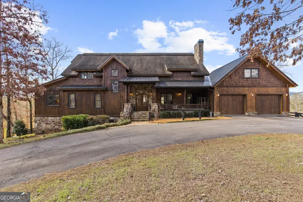 a front view of a house with basket ball court and outdoor seating
