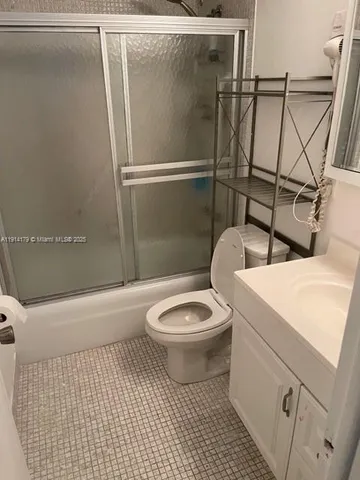 a bathroom with a toilet a sink and shower