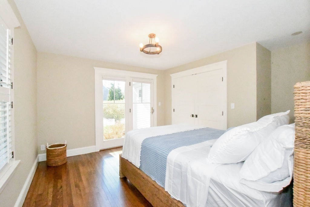 37 Holmes Street Marion, MA 02738 - Photo 16 of 37 a bedroom with a bed and wooden floor