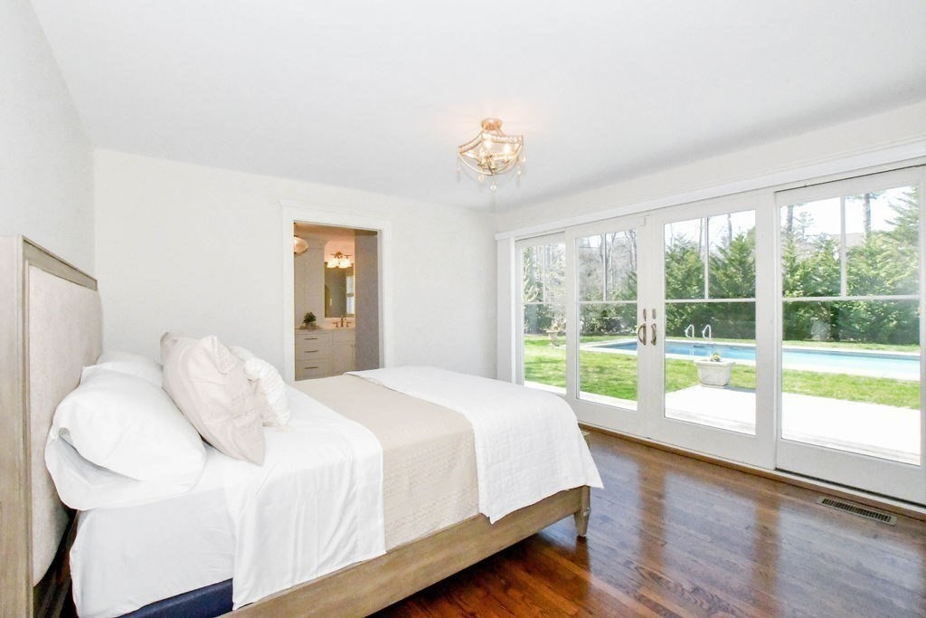 37 Holmes Street Marion, MA 02738 - Photo 18 of 37 a bedroom with a bed and a large window with outer view
