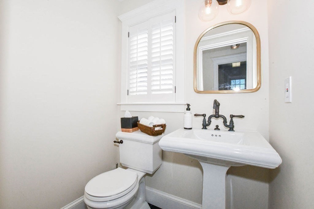 37 Holmes Street Marion, MA 02738 - Photo 22 of 37 a bathroom with a sink a toilet and mirror