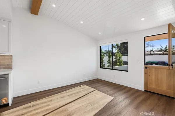 a view of a room with wooden floor and window