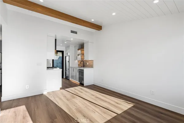 a view of a living room with wooden floor