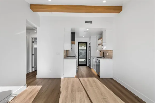 a kitchen with granite countertop a stove a sink and a refrigerator