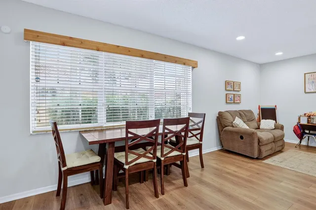 a view of a dining room with furniture and wooden floor