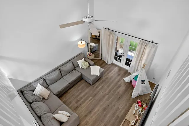 a living room with furniture and wooden floor