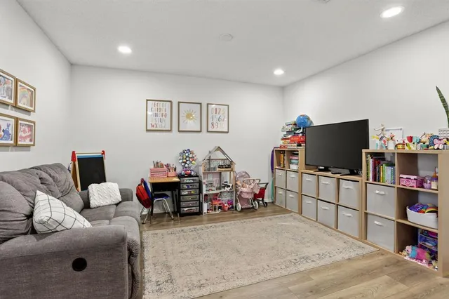a bedroom with furniture and a flat screen tv