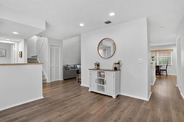 a view of a kitchen with cabinets stainless steel appliances and wooden floor