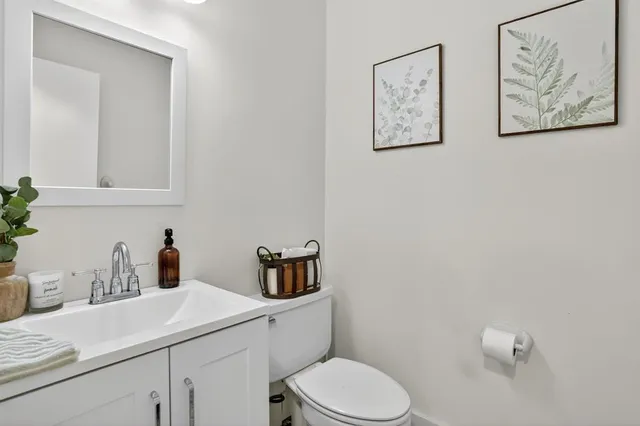 a bathroom with a toilet sink and mirror