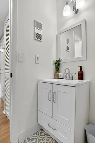 a bathroom with a sink a mirror and vanity
