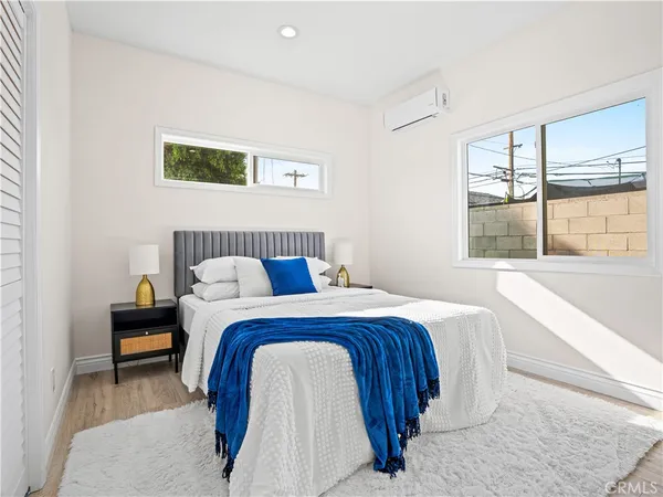 a bedroom with bed and window