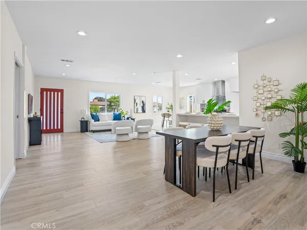 a dining room with furniture and wooden floor