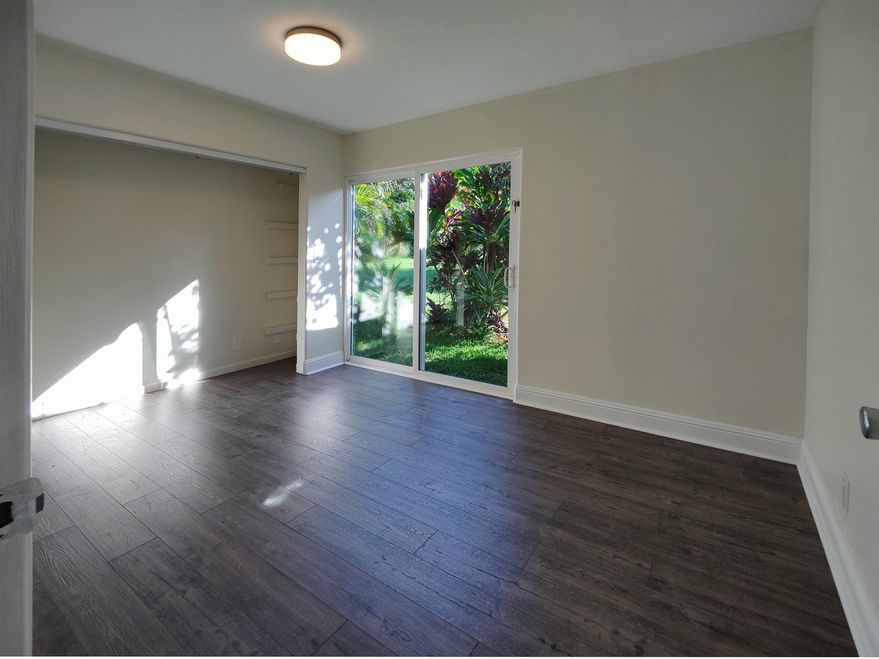 142 Peahi Road Haiku, HI 96708 - Photo 13 of 21 wooden floor in an empty room with a window