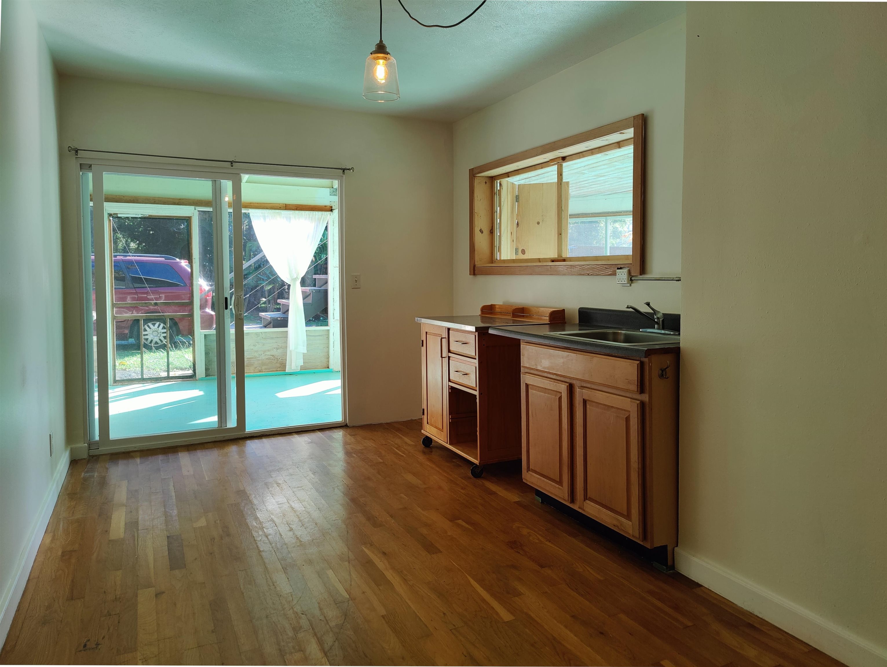 142 Peahi Road Haiku, HI 96708 - Photo 14 of 21 an empty room with wooden floor and windows