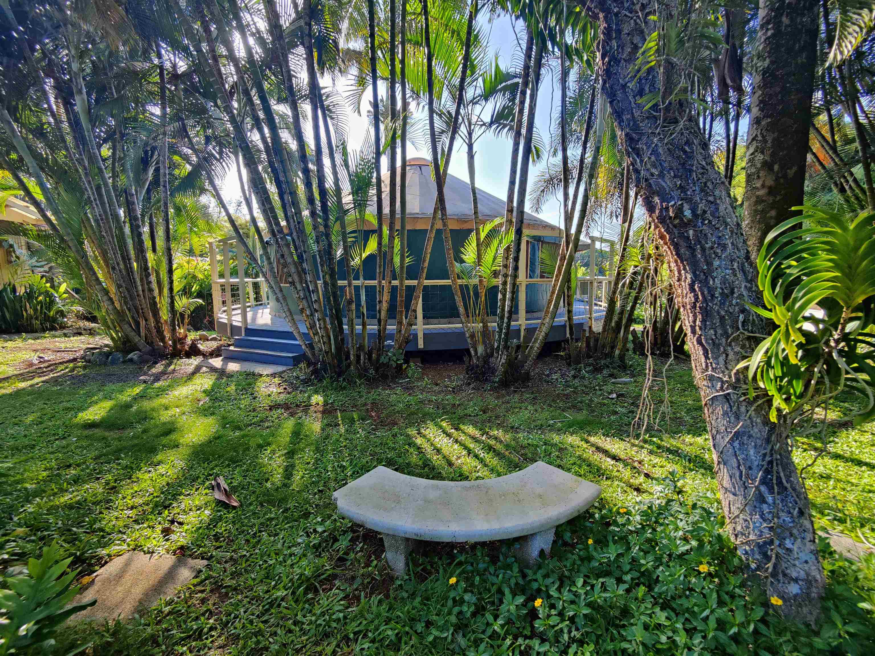 142 Peahi Road Haiku, HI 96708 - Photo 17 of 21 a backyard of a house with fountain table and chairs