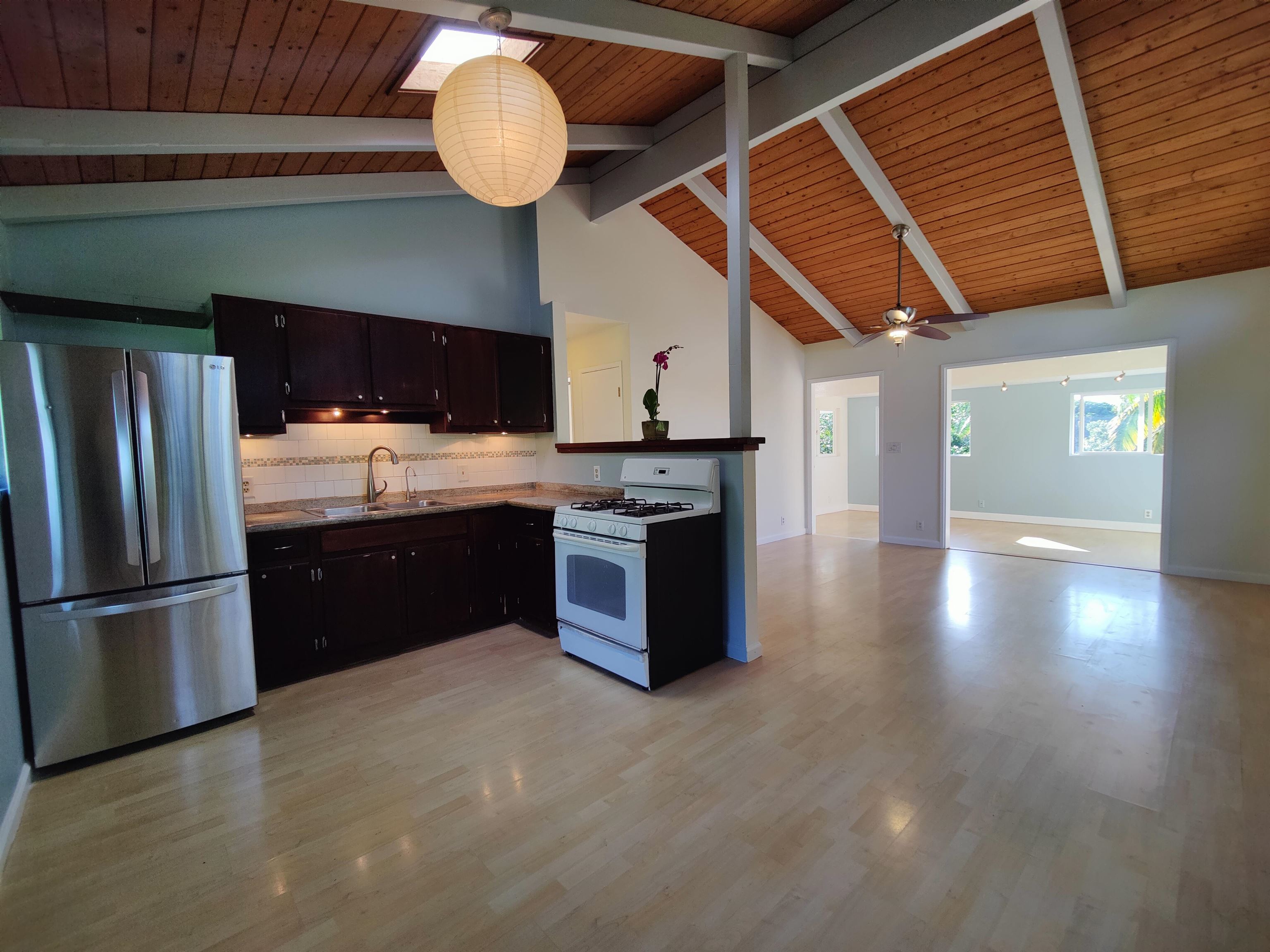 142 Peahi Road Haiku, HI 96708 - Photo 5 of 21 a kitchen with stainless steel appliances granite countertop a stove a sink and a refrigerator
