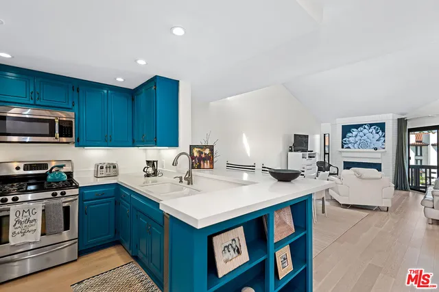 a kitchen with a sink stove top oven and microwave