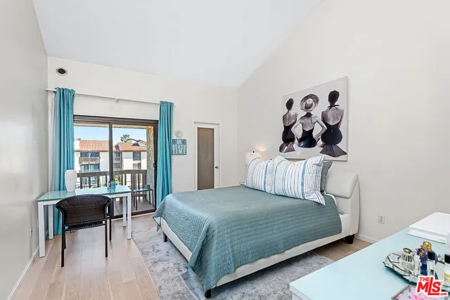 a bedroom with a bed and a table in it