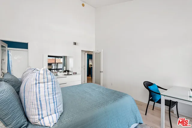 a bedroom with a bed and a chair in it